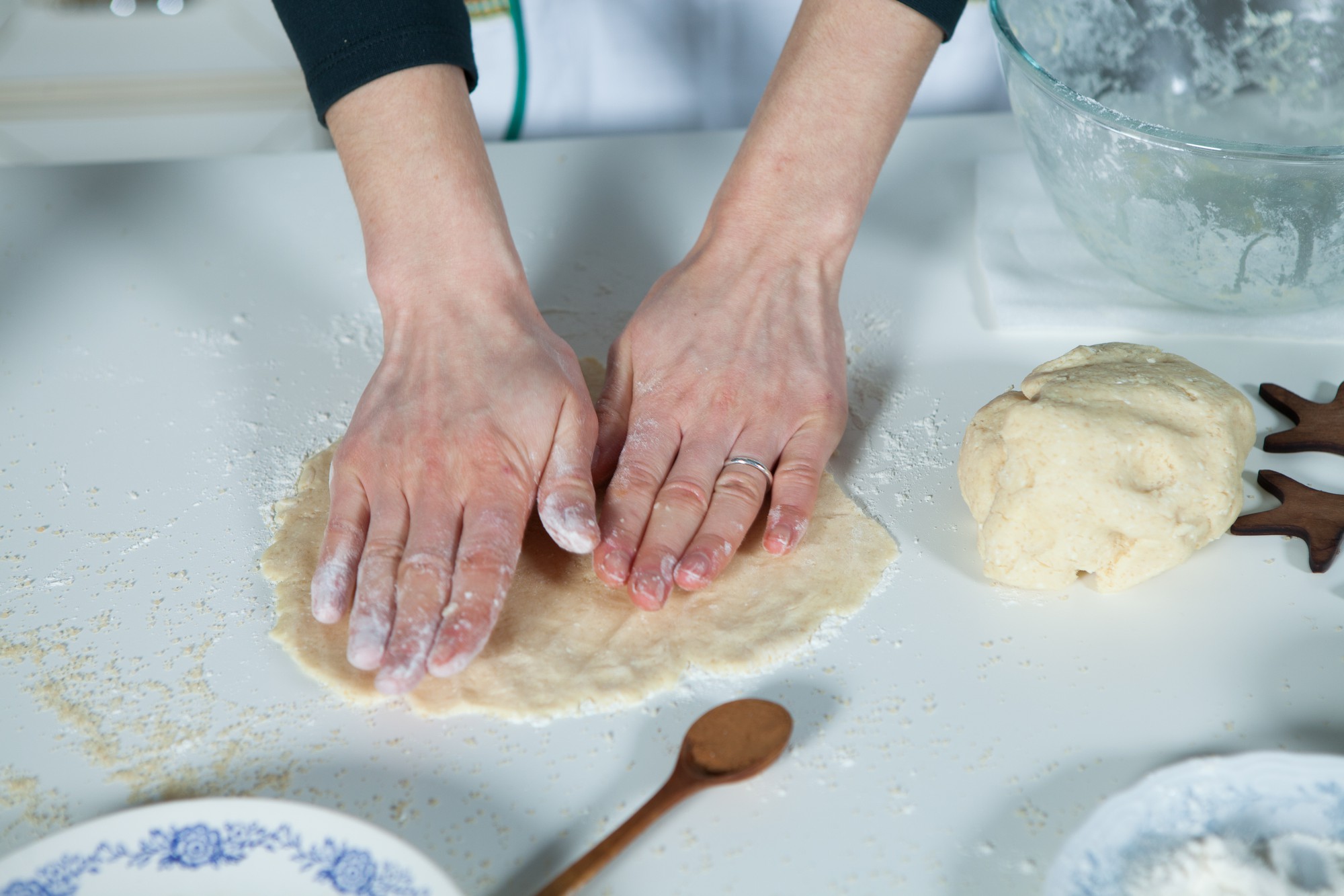 Close-up hands kneading dough